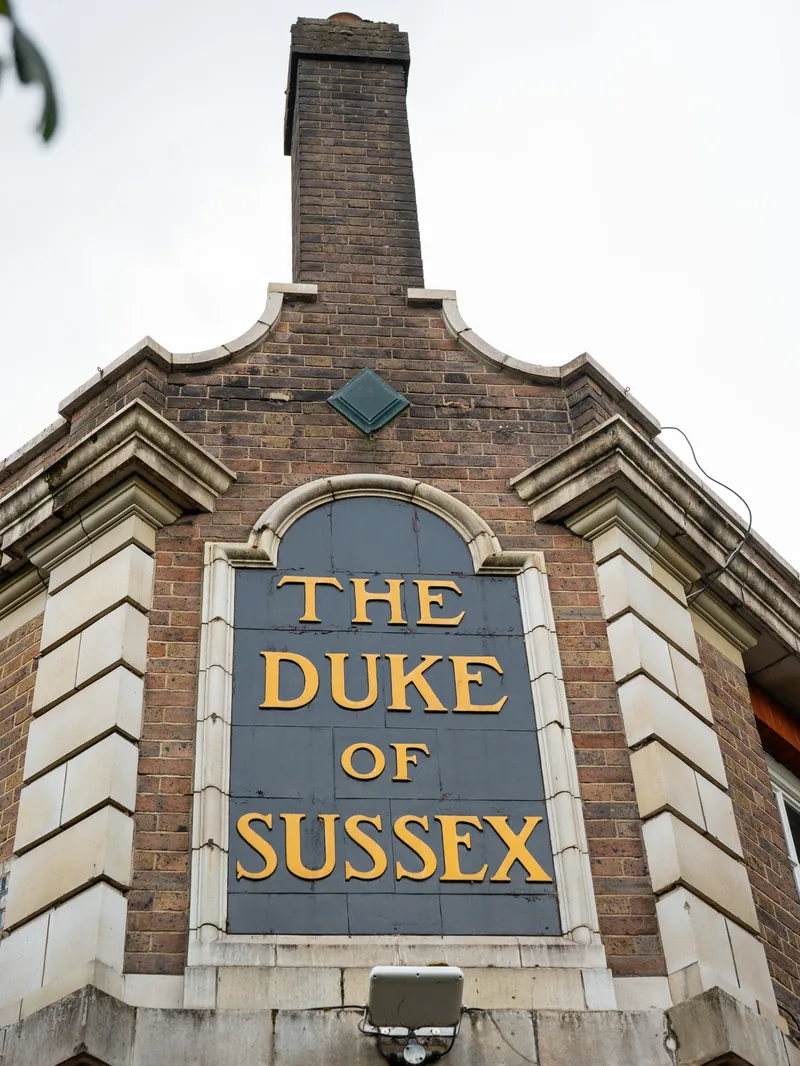 The Duke of Sussex name in gold lettering on the pub’s brick facade.
